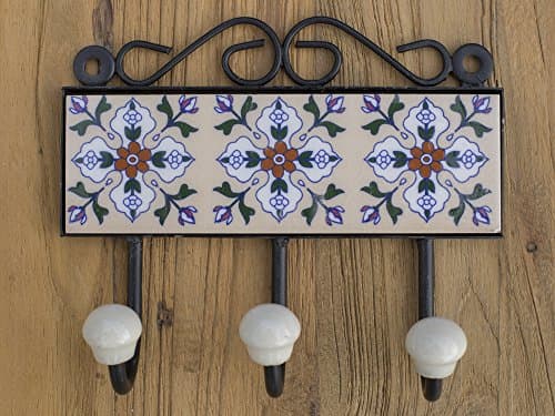Three metal hooks with ceramic tile.Traditional Indian design.